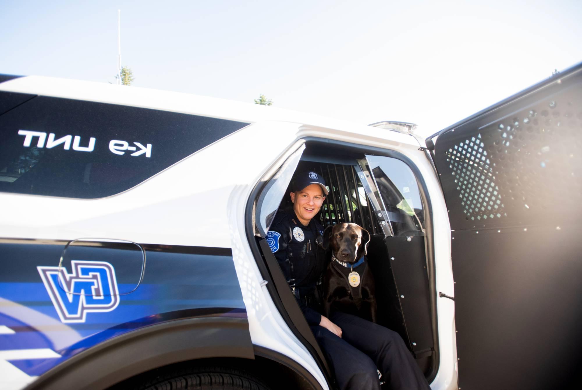 Kelsey Sietsema and Koda sitting together in the GVSU K9 Unit